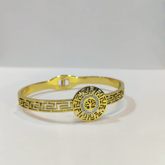 A Gold Bracelet With A Tree Of Life Design